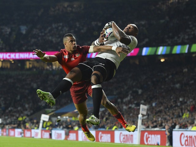 England's winger Anthony Watson (L) and Fiji's winger Nemani Nadolo jump for the ball during a Pool A match of the 2015 Rugby World Cup between England and Fiji at Twickenham stadium in south west London on September 18, 2015. 