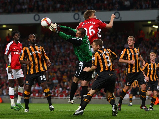 Goalkeeper Boaz Myhill of Hull City punches the ball clear from Nicklas Bendtner of Arsenal during the Barclays Premier League match between Arsenal and Hull City at the Emirates Stadium on September 27, 2008