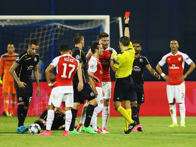 Olivier Giroud of Arsenal is shown the red card by referee Ovidiu Hategan during the UEFA Champions League Group F match between Dinamo Zagreb and Arsenal at Maksimir Stadium on September 16, 2015