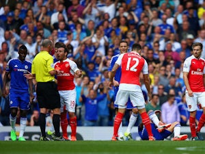 Santi Cazorla of Arsenal is shown a red card by referee Mike Dean during the Barclays Premier League match between Chelsea and Arsenal at Stamford Bridge on September 19, 2015