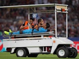 Rafinha of FC Barcelona is injured during the UEFA Champions League Group E match between AS Roma and FC Barcelona at Stadio Olimpico on September 16, 2015