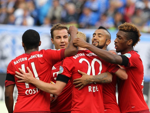 Bayern Munich's midfielder Sebastian Rode (C) is congratulated by teammates after scoring the 3-0 during the German first division Bundesliga football match SV Darmstadt 98 vs FC Bayern Munich in Darmstadt, western Germany on September 19, 2015