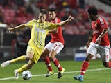 Astana's forward Baurzhan Dzholchiyev (L) vies with Benfica's Argentinian midfielder Nico Gaitan (C) and Benfica's defender Eliseu Santos (R) during the UEFA Champions League football match SL Benfica vs FC Astana at the Luz stadium in Lisbon on September