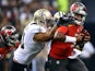 Jameis Winston #3 of the Tampa Bay Buccaneers is pursued by Kasim Edebali #91 of the New Orleans Saints during the first quarter of a game at the Mercedes-Benz Superdome on September 20, 2015 in New Orleans, Louisiana.