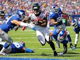 Tevin Coleman #26 of the Atlanta Falcons runs the ball past Mark Herzlich #94 and Uani' Unga #47 of the New York Giants for a first quarter touchdown at MetLife Stadium on September 20, 2015 in East Rutherford, New Jersey.
