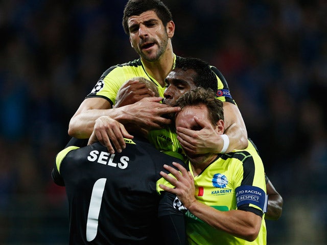 Goalkeeper, Matz Sels of Gent is congratulated by team mates Sven Kums, Renato Cardoso Neto and Stefan Mitrovic after he saves a penalty in the final minutes during the UEFA Champions League Group H match between KAA Gent and Olympique Lyonnais held at Gh