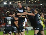 George Williams of Wigan Warriors is mobbed by teammates after scoring his second half try during the First Utility Super League match between St Helens and Wigan Warriors at Langtree Park on September 18, 2015 in St Helens, England.