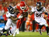 Jamaal Charles #25 of the Kansas City Chiefs is tackled by Darius Kilgo #98 of the Denver Broncos during the game at Arrowhead Stadium on September 17, 2015 in Kansas City, Missouri.