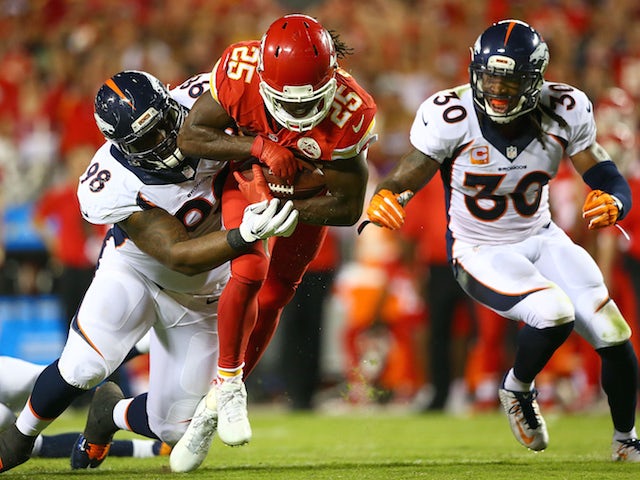 Jamaal Charles #25 of the Kansas City Chiefs is tackled by Darius Kilgo #98 of the Denver Broncos during the game at Arrowhead Stadium on September 17, 2015 in Kansas City, Missouri.