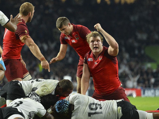 England's lock Joe Launchbury (R) reacts as England's back row Billy Vunipola scores a try during a Pool A match of the 2015 Rugby World Cup between England and Fiji at Twickenham stadium in south west London on September 18, 2015