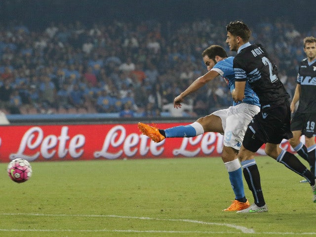 Napoli's Argentinian-French forward Gonzalo Higuain (L) scores past Lazio's Dutch defender Wesley Hoedt during the Italian Serie A football match SSC Napoli vs SS Lazio on September 20, 2015 at the San Paolo stadium in Naples.