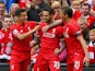 Danny Ings of Liverpool (28) celebrates with team mates as he scores their first goal during the Barclays Premier League match between Liverpool and Norwich City at Anfield on September 20, 2015