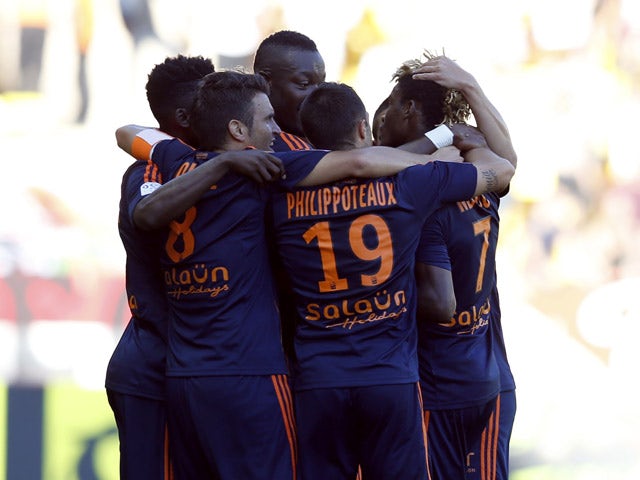 Lorient's forward Ibrahim Didier Ndong (R) celebrates with teammates after scoring a goal during the French L1 football match Monaco (ASM) vs Lorient (FCL) on September 20, 2015