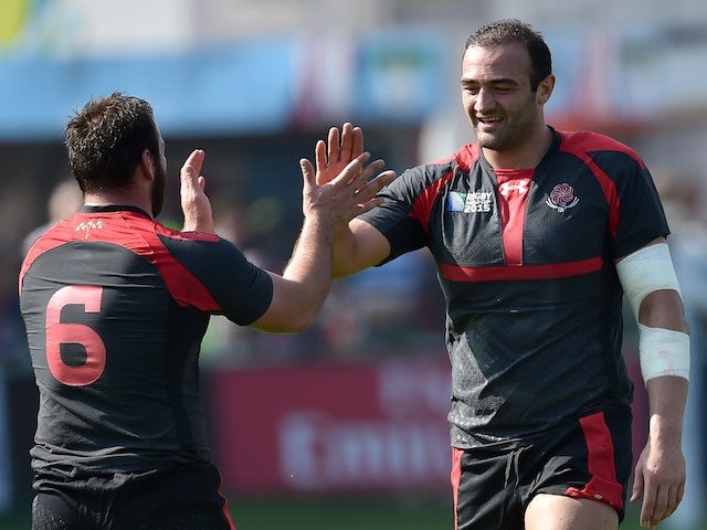 Tonga's Mamuka Gorgodze celebrates his try with teammate Sione Kalamafoni during the Rugby World Cup game with Georgia on September 19, 2015
