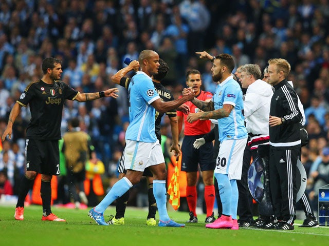 An injured Vincent Kompany of Manchester City is substituted for Nicolas Otamendi of Manchester City during the UEFA Champions League Group D match between Manchester City FC and Juventus at the Etihad Stadium on September 15, 2015