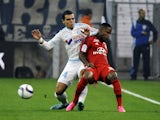 Marseille's Dutch defender Karim Rekik (L) vies with Lyon's French forward Claudio Beauvue during the French L1 football match Marseille (OM) vs Lyon (OL) on September 20, 2015 at Velodrome Stadium in Marseille, southern France. 