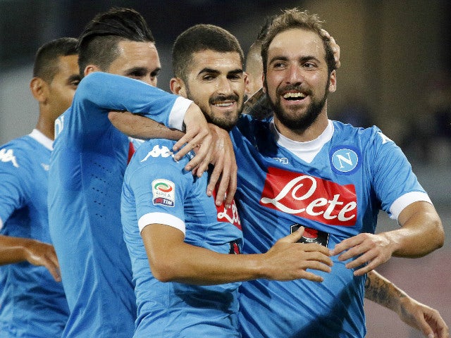 Napoli's Argentinian-French forward Gonzalo Higuain (R) celebrates with teammates after scoring during the Italian Serie A football match SSC Napoli vs SS Lazio on September 20, 2015 at the San Paolo stadium in Naples.