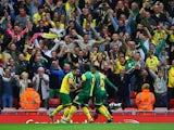 Russell Martin of Norwich City (L) celebrates in front of the travelling fans with team mates as he scores their first and equalising goal during the Barclays Premier League match between Liverpool and Norwich City at Anfield on September 20, 2015