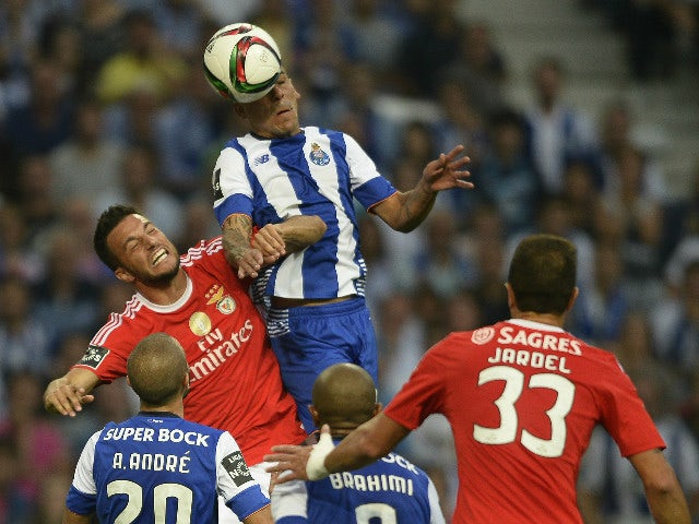 Porto's Uruguayan defender Maxi Pereira (R) heads the ball with Benfica's Greek midfielder Andreas Samaris during the Portuguese league football match FC Porto vs SL Benfica at the Dragao stadium in Porto, on September 20, 2015.