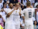 Real Madrid's French forward Karim Benzema (L) celebrates with Real Madrid's Portuguese defender Pepe (C) and Real Madrid's German midfielder Toni Kroos after scoring a goal during the Spanish league football match Real Madrid CF vs Granada FC at the Sant