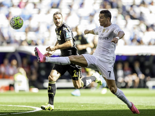 Cristiano Ronaldo (R) of Real Madrid CF competes for the ball with David Rodriguez Lomban (L) of Granada CF during the La Liga match between Real Madrid CF and Granada CF at Estadio Santiago Bernabeu on September 19, 2015 in Madrid, Spain.