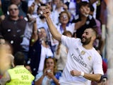Real Madrid's French forward Karim Benzema celebrates after scoring a goal during the Spanish league football match Real Madrid CF vs Granada FC at the Santiago Bernabeu stadium in Madrid on Spetember 19, 2015