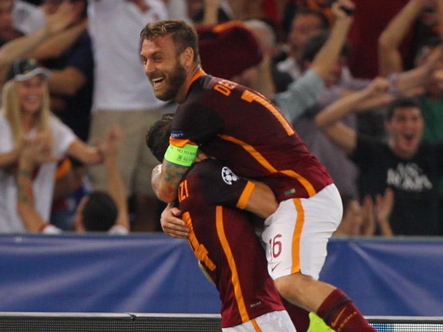 Alessandro Florenzi (L) with his teammate Daniele De Rossi of AS Roma celebrates after scoring the team's first goal during the UEFA Champions League Group E match between AS Roma and FC Barcelona at Stadio Olimpico on September 16, 2015