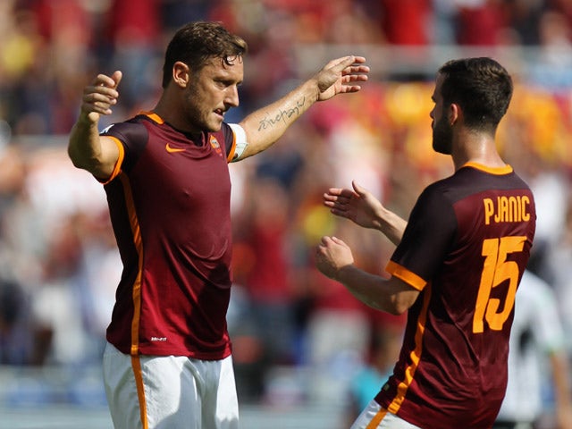 Francesco Totti with his teammate Miralem Pjanic of AS Roma celebrates after scoring their first goal during the Serie A match between AS Roma and US Sassuolo Calcio at Stadio Olimpico on September 20, 2015