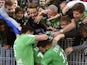 Saint-Etienne's French forward Jonathan Bamba celebrates with teammates and supporters after scoring a goal during the French Ligue 1 football match between AS Saint-Etienne and FC Nantes on September 20, 2015