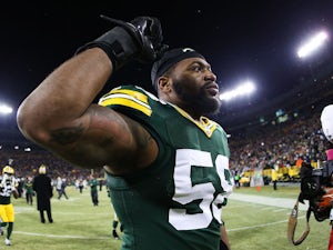Sam Barrington #58 of the Green Bay Packers acknowledges fans as he walks off of the field after the defeated the Detroit Lions 30 to 20 to take the NFC North Championship at Lambeau Field on December 28, 2014 