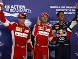 Sebastian Vettel of Germany and Ferrari celebrates in Parc Ferme next to Daniel Ricciardo of Australia and Infiniti Red Bull Racing and Kimi Raikkonen of Finland and Ferrari after claiming pole position during qualifying for the Formula One Grand Prix of 