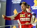 Sebastian Vettel of Germany and Ferrari celebrates on the podium after winning the Formula One Grand Prix of Singapore at Marina Bay Street Circuit on September 20, 2015