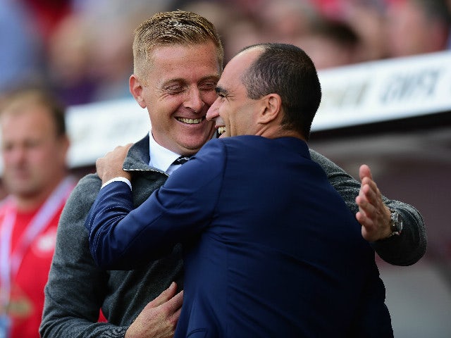 Garry Monk Manager of Swansea City and Roberto Martinez Manager of Everton greet prior to the Barclays Premier League match between Swansea City and Everton at the Liberty Stadium on September 19, 2015 in Swansea, United Kingdom.