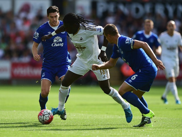 Bafetimbi Gomis of Swansea City and Phil Jagielka of Everton compete for the ball during the Barclays Premier League match between Swansea City and Everton at the Liberty Stadium on September 19, 2015 in Swansea, United Kingdom.