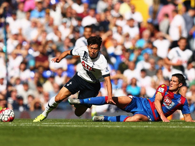 Son Heung-Min of Tottenham Hotspur is challenged by Martin Kelly of Crystal Palace during the Barclays Premier League match between Tottenham Hotspur and Crystal Palace at White Hart Lane on September 20, 2015