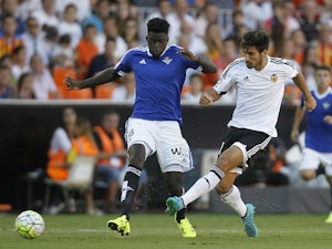 Betis' French Senegalese defender Alfred N'Diaye (L) vies with Valencia's Portuguese midfielder Andre Gomes during the Spanish league football match Valencia CF vs Real Betis Balompie at the Mestalla stadium in Valencia on September 19, 2015.