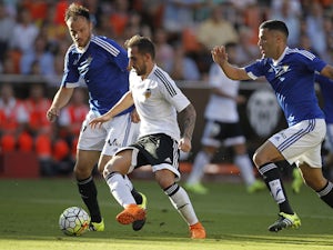 Betis' defender Bruno Gonzalez (R) and Betis' German defender Heiko Westermann (L) vie with Valencia's forward Paco Alcacer during the Spanish league football match Valencia CF vs Real Betis Balompie at the Mestalla stadium in Valencia on September 19, 20