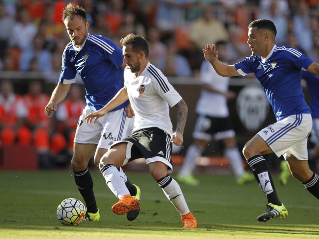 Betis' defender Bruno Gonzalez (R) and Betis' German defender Heiko Westermann (L) vie with Valencia's forward Paco Alcacer during the Spanish league football match Valencia CF vs Real Betis Balompie at the Mestalla stadium in Valencia on September 19, 20