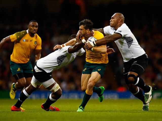 Adam Ashley-Cooper of Australia is tackled by Leone Nakarawa (L) and Nemani Nadolo of Fiji during the 2015 Rugby World Cup Pool A match between Australia and Fiji at the Millennium Stadium on September 23, 2015