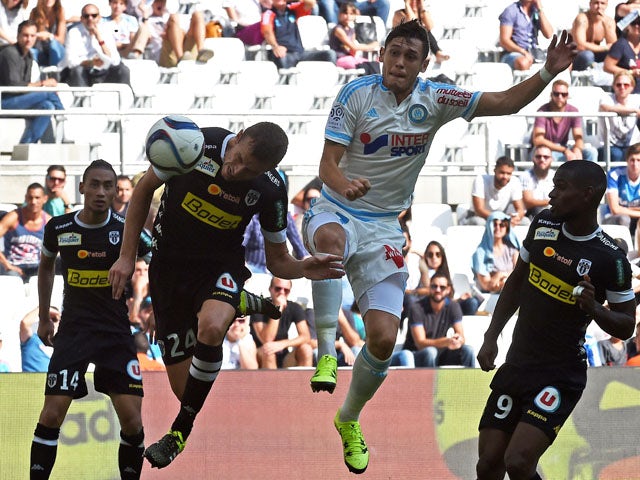 Angers' French defender Romain Thomas (L) scores a goal against Marseille's Argentinian forward Lucas Ocampos (R) during the French L1 football match between Marseille (OM) and Angers, on september 27, 2015