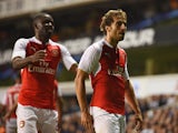 Mathieu Flamini of Arsenal celebrates with Joel Campbell as he scores their first goal during the Capital One Cup third round match between Tottenham Hotspur and Arsenal at White Hart Lane on September 23, 2015