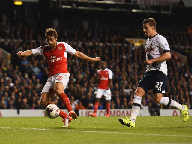 Mathieu Flamini of Arsenal scores their first goal as Kevin Wimmer of Tottenham Hotspur looks on during the Capital One Cup third round match between Tottenham Hotspur and Arsenal at White Hart Lane on September 23, 2015