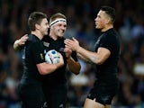 Beauden Barrett (L) of the New Zealand All Blacks celebrates with Sam Cane and Sonny Bill Williams after scoring his teams fourth try during the 2015 Rugby World Cup Pool C match between New Zealand and Namibia at the Olympic Stadium on September 24, 2015