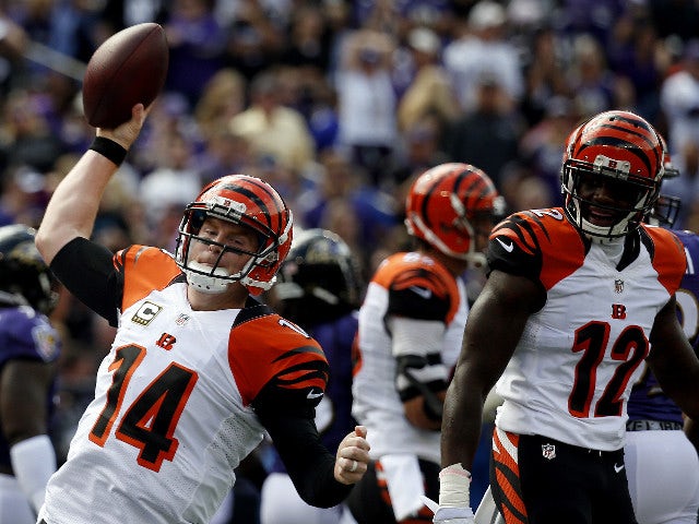 Quarterback Andy Dalton #14 of the Cincinnati Bengals celebrates with wide receiver Mohamed Sanu #12 of the Cincinnati Bengals after scoring a first quarter touchdown during a game against the Baltimore Ravens at M&T Bank Stadium on September 27, 2015 in 