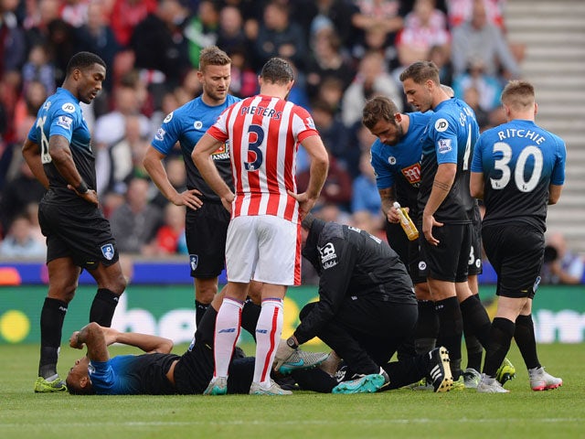 Callum Wilson of Bournemouth lies on the ground after his injury during the Barclays Premier League match between Stoke City and A.F.C. Bournemouth at Britannia Stadium on September 26, 2015