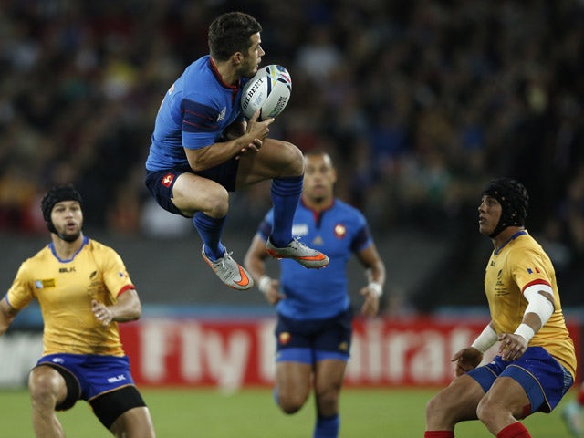 France's full-back Brice Dulin (C) jumps for the ball next to Romania's wing Adrian Apostol (R) and Romania's fly half Danut Dumbrava (L) during a Pool D match of the 2015 Rugby World Cup between France and Romania at the Olympic stadium, east London, on 