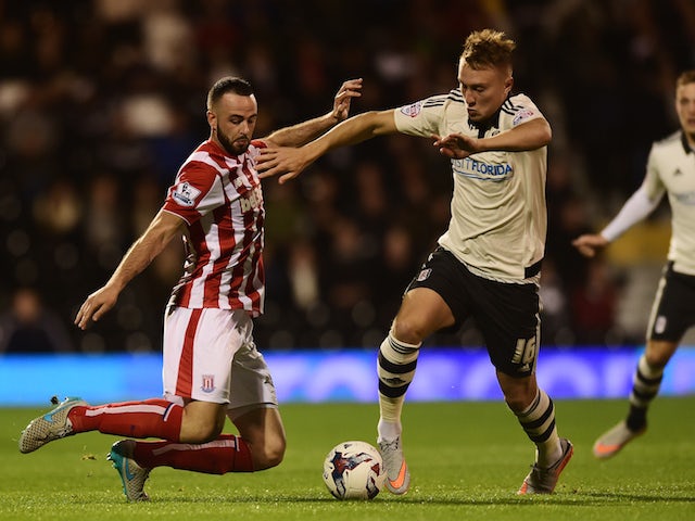 Cauley Woodrow of Fulham is tackled by Marc Wilson of Stoke City during the Capital One Cup Third Round match between Fulham and Stoke City at Craven Cottage on September 22, 2015 in London, United Kingdom.