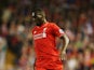 Christian Benteke of Liverpool runs with the ball during the Barclays Premier League match between Liverpool and A.F.C. Bournemouth at Anfield on August 17, 2015