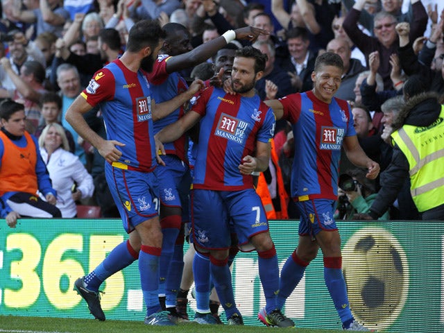 Crystal Palaces French midfielder Yohan Cabaye (C) celebrates after scoring the opening goal from the penalty spot during the English Premier League football match between Watford and Crystal Palace at Vicarage Road Stadium in Watford, north of London on 