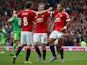Memphis Depay (R) of Manchester United celebrates scoring his team's first goal with his team mate Juan Mata (L) and Wayne Rooney (C) during the Barclays Premier League match between Manchester United and Sunderland at Old Trafford on September 26, 2015 i